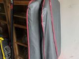 two umbrellas hanging on a rack in a garage