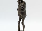 an image of a bronze statue of a woman holding her head in her hands