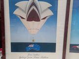 two framed pictures of a hot air balloon flying over the water