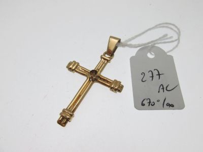 une croix en or à laquelle est attachée une étiquette indiquant le prix