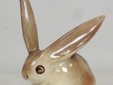 a small ceramic rabbit sitting on a white surface