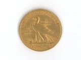 a gold coin with a bird on it on a white surface