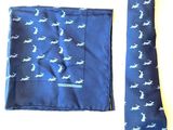 a blue tie and a blue pocket square on a table
