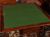 a table with a green cloth on it in a living room