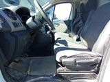 the interior of a white van with the door open and the driver ' s seat down