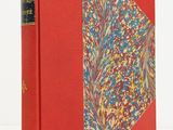 a red book with a floral design on the cover