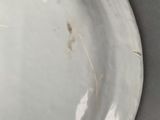 a white plate with a brown patt on it