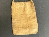 an old purse with a rope hanging from it ' s side