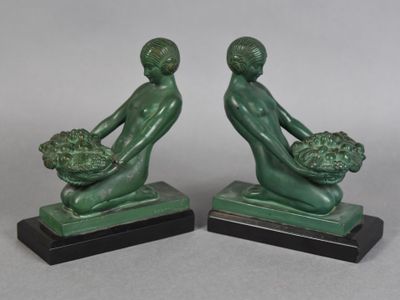 pair of art deco bookends of a man and a woman holding a basket of flowers
