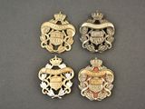 four badges of the royal family, including a crown, a shield, and a shield