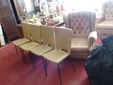 four chairs in a room with a red carpet