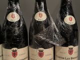 six bottles of wine wrapped in plastic sit on a table