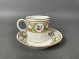 a cup and saucer sitting on a table