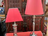 deux lampes rouges posées sur une table rouge dans une pièce