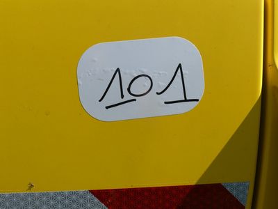 a close up of a yellow bus with a number on it