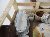 a wooden crate with a bunch of dishes in it