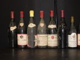 several bottles of wine are lined up on a shelf