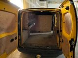 a yellow van with its door open in a garage