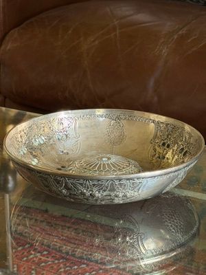 a bowl sitting on a glass table with a brown couch in the background