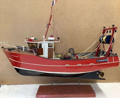 a model of a red boat on display on a table