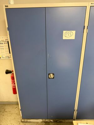 two blue lockers in a room with a fire extinguisor