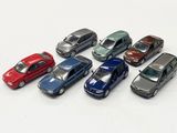 several toy cars are lined up in a row on a white surface