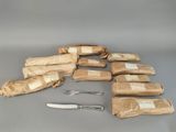 many bags of food and a knife and fork on the table