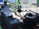 a close up of a green vehicle with a driver ' s seat