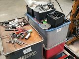 a pile of tools sitting on a table in a garage