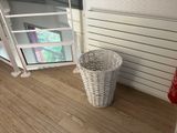 a basket that is sitting on the floor next to a radiator
