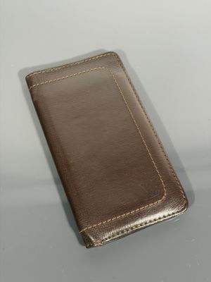 leather case for a cell phone sitting on a table