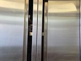 two stainless steel doors that are open in a kitchen