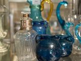 many glass vases on a glass shelf in a glass case