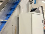 a man that is standing in front of a conveyor belt