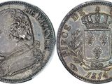a silver coin with a crown on top of it