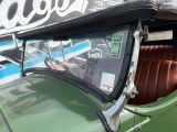 a close up of a green car with a sign on it