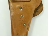 a brown leather holster with a metal clip on it