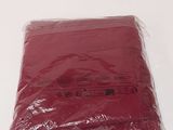 a bag of red tissue sitting on a white table