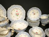 a lot of plates and cups that are sitting on a table