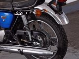 a blue and black motorcycle parked in a parking lot