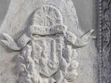 a stone plaque with a coat of arms and a shield on it