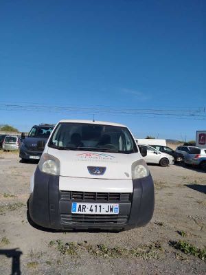 a small white van parked in a parking lot