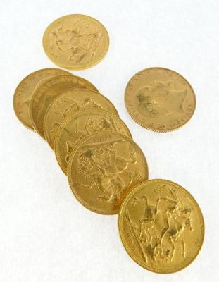 a lot of gold coins sitting on a white surface
