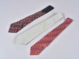 three different colored ties laying next to each other on a white surface