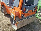 a small orange machine that is sitting in the dirt