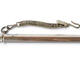 a silver pipe that has a chain on it