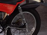a red and black motorcycle parked in a parking garage