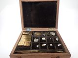 a small wooden box with many different items inside of it