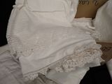 a cardboard box with a white dress on top of a bed