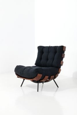 an image of a black chair with a wooden frame and a black cushion